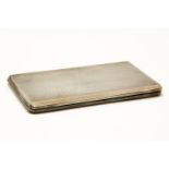 An engine turned silver and copper banded cigarette case