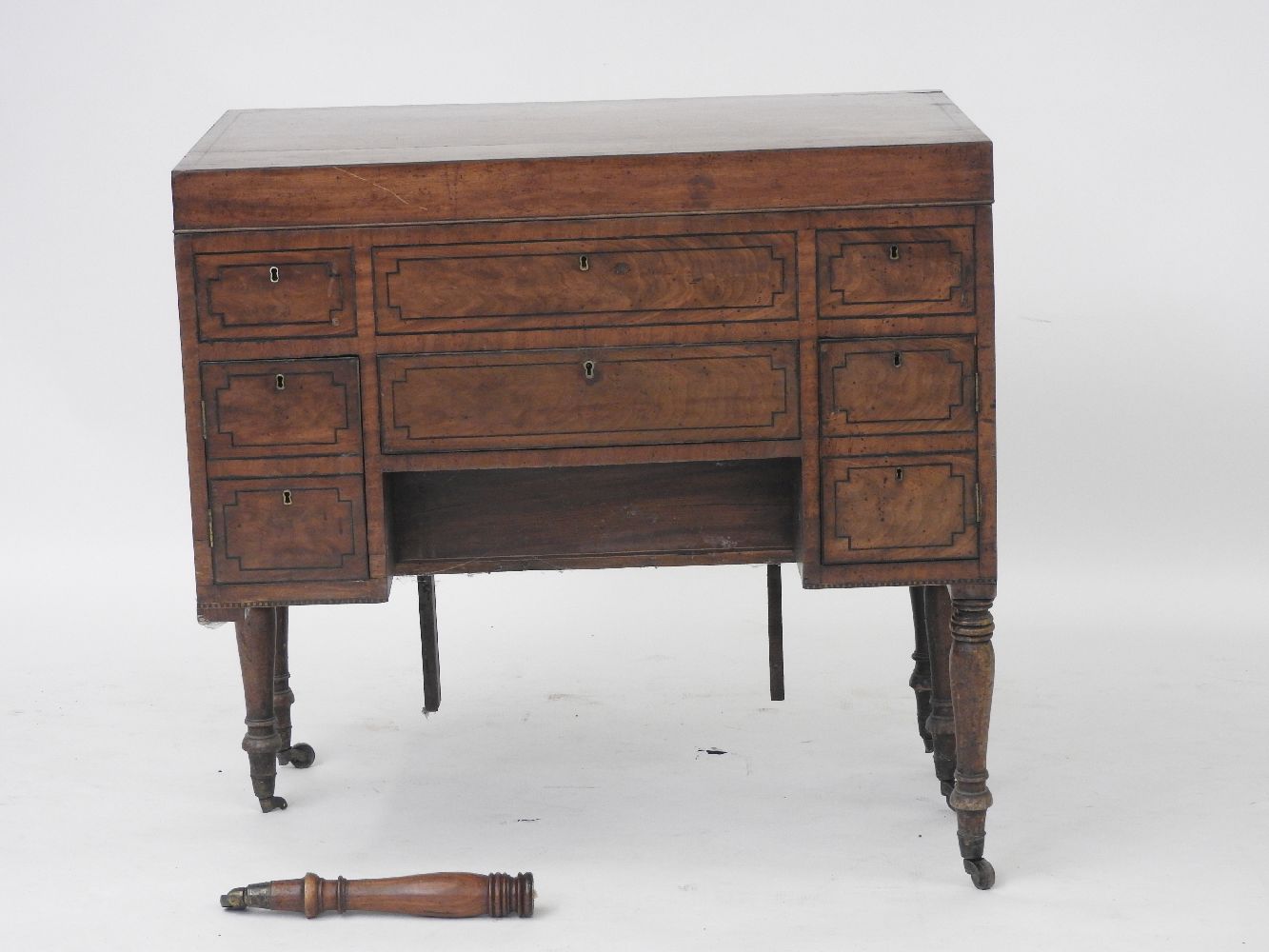 A late George III mahogany and ebony strung washstand, the hinged top above central drawer flanked