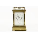 A French brass carriage clock, with alarm and repeat mechanisms, striking the half hours. Dial