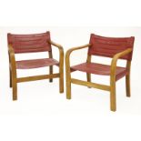 A pair of oak low armchairs, with red slung seats and backs (2)