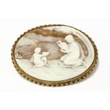 A 9ct gold mounted shell cameo brooch of a young maiden in a landscape setting