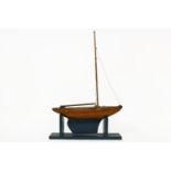 A wooden pond yacht, on a stand. 70cm high