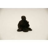 A small Japanese bronze figure of a seated craftsman, 6cm high