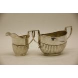 A 20th century English silver sugar dish and cream jug, approximately 16oz