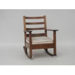 An oak Liberty style rocking chair