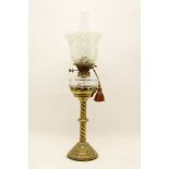A Victorian brass oil lamp with glass reservoir and shade, 72cm high