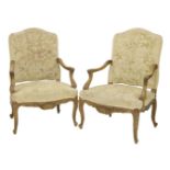 A pair of Louis XV-style carved fauteuils,with cream needlework upholstery (2)