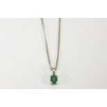 An 18ct white gold single stone oval cut emerald pendant, on an 18ct gold curb link chain