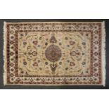 A cream ground Persian hand made wool rug with scrolling foliate design, 180cm x 120cm