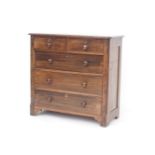 A walnut chest of two short over three long drawers, turned knobs and shaped feet, 103cm wide