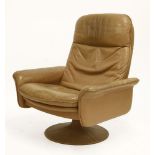 A De Sede tan leather reclining lounger, on a revolving stand