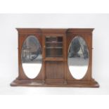 An Edwardian mahogany overmantle mirror, with a central glazed cupboard, 145cm wide, 95cm high