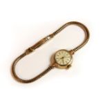 A ladies 9ct gold Talis mechanical bracelet watch, with cream dial, gilt baton numerals, and