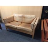 A Danish light brown leather settee, 155cm wide