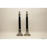 A pair of silver plated and black granite Corinthian column table lamps on stepped bases