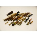 A collection of Victorian and later pipe tampers and seals, including a carved ivory stockinged