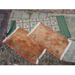 A pair of peach ground rugs, and a latticed rug