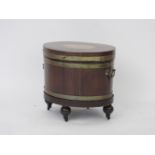 A Regency mahogany oval collection cellerette, the top inlaid with fan motif, the lifting lid