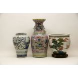 A Chinese famille rose vase, late Qing dynasty, painted with two peacocks by peony and prunus on a