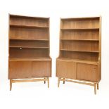 A pair of Danish teak high-sided cabinets, each with three shelves over sliding cupboards, 100cm