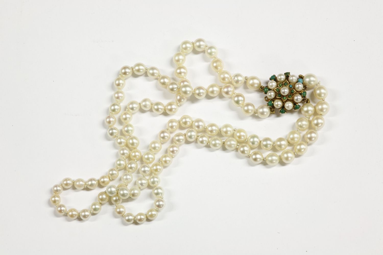 A two row graduated cultured pearl necklace with gold cultured pearl and stained howlite clasp,