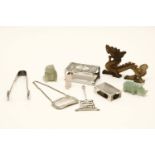 A small assortment of silver, to include matchbox holders, tongs, decanter labels, and carved