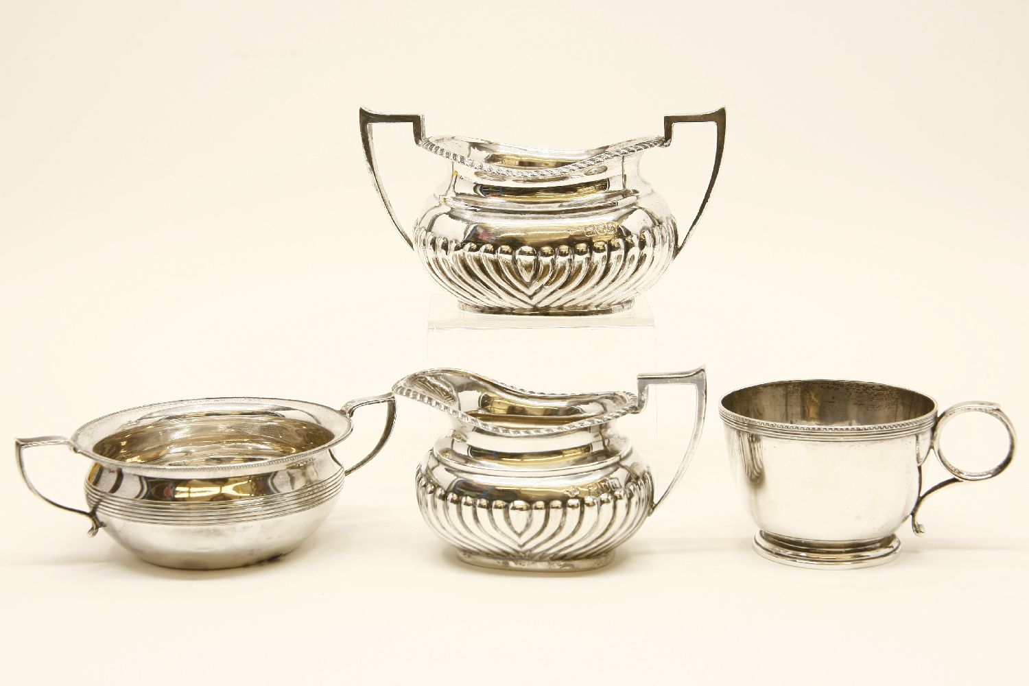 A 20th century silver cream jug with half gadrooned body, together with a matching sugar bowl, marks