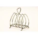A silver four division toast rack, with heart shaped handle on outswept feet, together with a pair