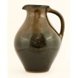 *Andrew Crouch (b.1955),a large jug, with a mottled copper glaze, over a dark brown ground,