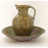 John Calver,a large stoneware bowl and jug, each decorated with flowers on a mottled coloured