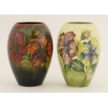 A Walter Moorcroft ovoid vase,decorated with flowers against a graduated deep red ground,
