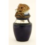 A Royal Doulton stoneware tobacco jar and cover,modelled as a figure wearing a bow tie with a pipe