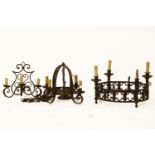 A large gothic style iron chandelier of ring form, together with a smaller similar four light