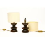 A pair of turned possibly lignum vitae and silver mounted table lamps, each fitted with cream shade,