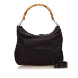 A Gucci 'Bamboo' nylon handbag, with a black nylon body, a bamboo handle, a top magnetic closure and