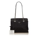 A Prada nylon shoulder bag, with a black nylon body, long chain straps, a crossover flap, top zip