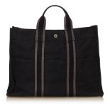 An Hermès 'Fourre Tout MM' tote bag, with a black and grey canvas body, exterior slip pockets, top