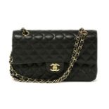 A Chanel black caviar leather 2.55 double flap medium handbag,featuring maker's iconic black quilted