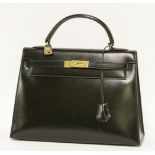 An Hermès 32 black box calf leather 'Kelly' handbag,crafted from black box calf leather, featuring a