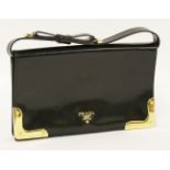 A Prada black patent leather clutch handbag,with gold-tone hardware and corner mounts, bow detail to