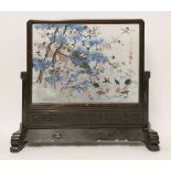 A Chinese table screen, early 20th century, carved with stylised chilong confronting a bat, all
