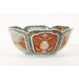 A Japanese imari bowl, with lobed panels. 25cm across