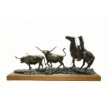 Lyle E Johnson, 20th century American, a cowboy and two longhorn steers, bronze, signed to the