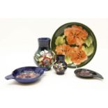 A Moorcroft plate hibiscus green ground, together with a Moorcroft vase, Iris pattern and a small