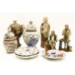 A Japanese Satsuma vase with triple scroll handles, together with two tradesmen figures, a figure of