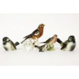 A collection of birds, to include Goebel examples, Swarovski examples and Beswick