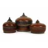 Three Indian turned wooden and red painted boxes, of onion form, the largest 15cm diameter