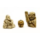 A collection of two Japanese netsuke, c.1900 including a horn Jurogin, an ivory seated man with a