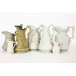 A collection of stoneware relief moulded jugs, to include a ‘York Minster’ jug, 24cm high,