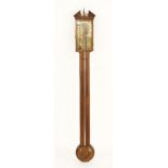 A George III mahogany inlaid stick barometer, the broken arch pediment centred with an urn, over a